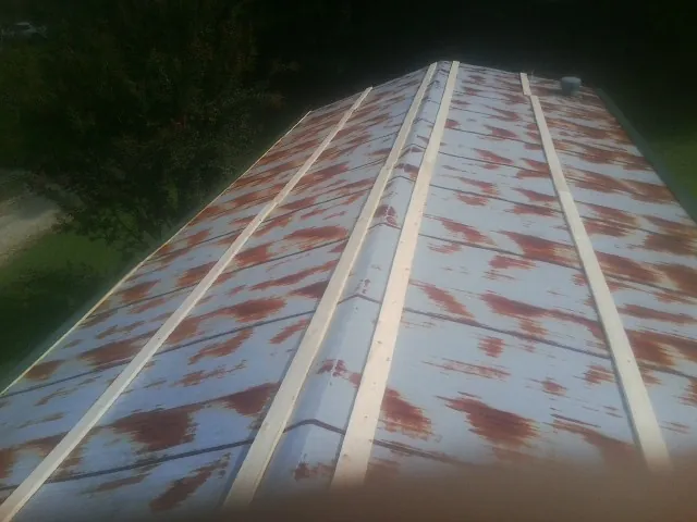 Rusted metal roof panels with new wood purlins before replacement — Storm Damage Roof Repair in Mayville by Roofing Brothers